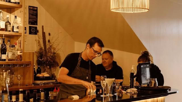 Cuisine-Good-Food-Guide-2024-Arc-Restaurant-Wanaka-Jake-making-cocktail-at-bar