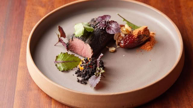 Cuisine-Good-Food-Guide-2024-Sid-at-The-French-Café-Venison,-romesco,-black-pudding,-medjool-date,-smoked-cashews-credit-Josh-Griggs