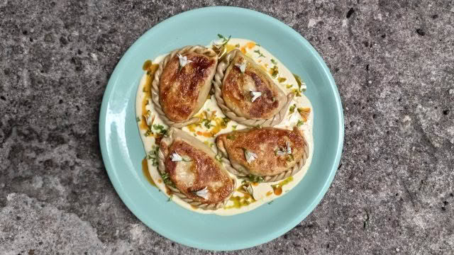 Cuisine Good Food Guide 2026 Graze Onion weed pierogies with yoghurt sauce and chili oil – Photo credit Stina Persen