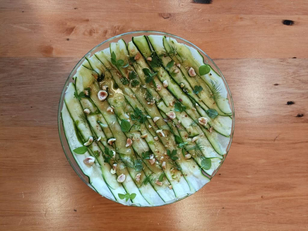 Cuisine Good Food Guide 2026 Graze Zucchini with parsley and fennel yoghurt topped with hazelnuts, herbs and fig leaf oil – Photo credit Stina Persen