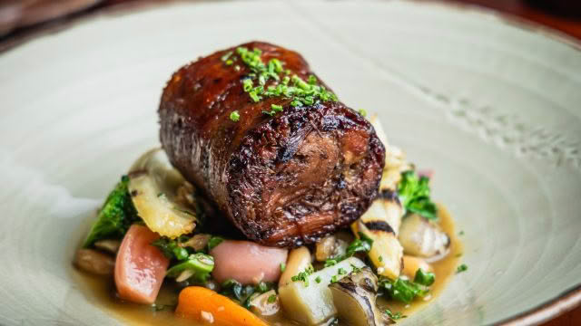 Cuisine Good Food Guide 2026 The Bistro Bacon Wrapped Lamb Shoulder, Cannellini Beans, Petite Vegetables, Anchovy Caramel