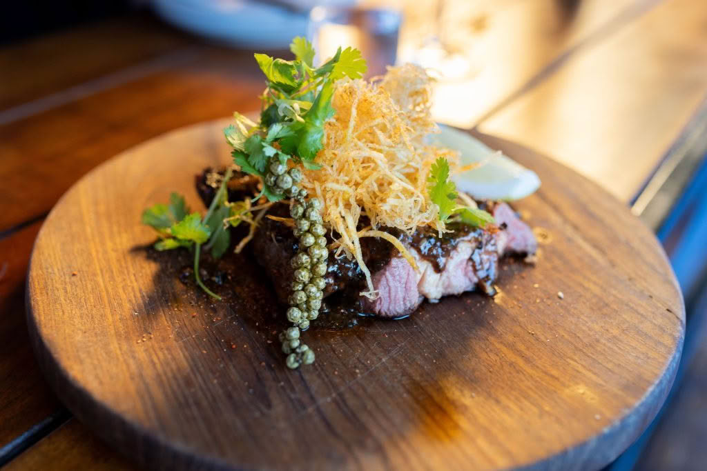 Cuisine Good Food Guide 2026 The Blue Breeze Inn CHARRED BONE-IN RIBEYE Kampot pepper & crunchy matchstick potatoes