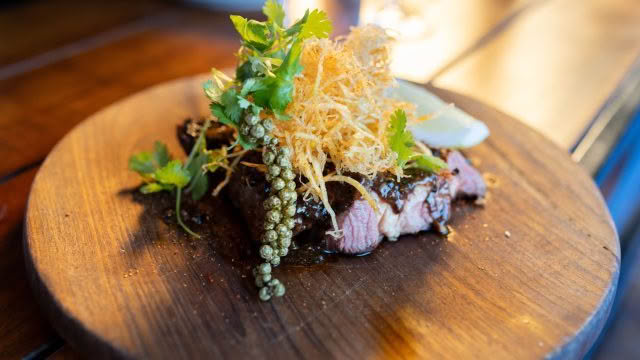 Cuisine Good Food Guide 2026 The Blue Breeze Inn CHARRED BONE-IN RIBEYE Kampot pepper & crunchy matchstick potatoes